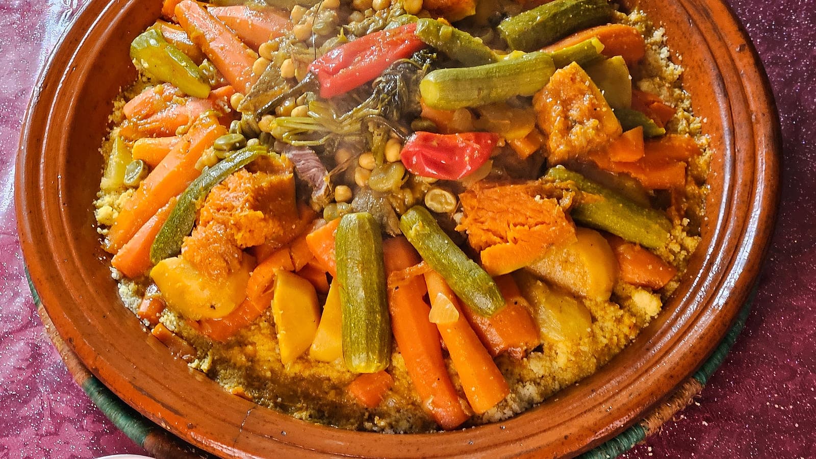 Steamed Moroccan couscous piled high with vegetables and broth