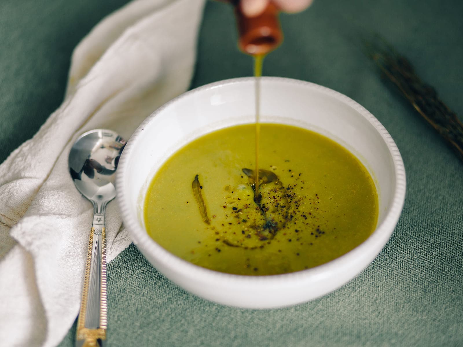 Bowl of thick Moroccan bissara fava bean soup with olive oil, paprika and cumin on top