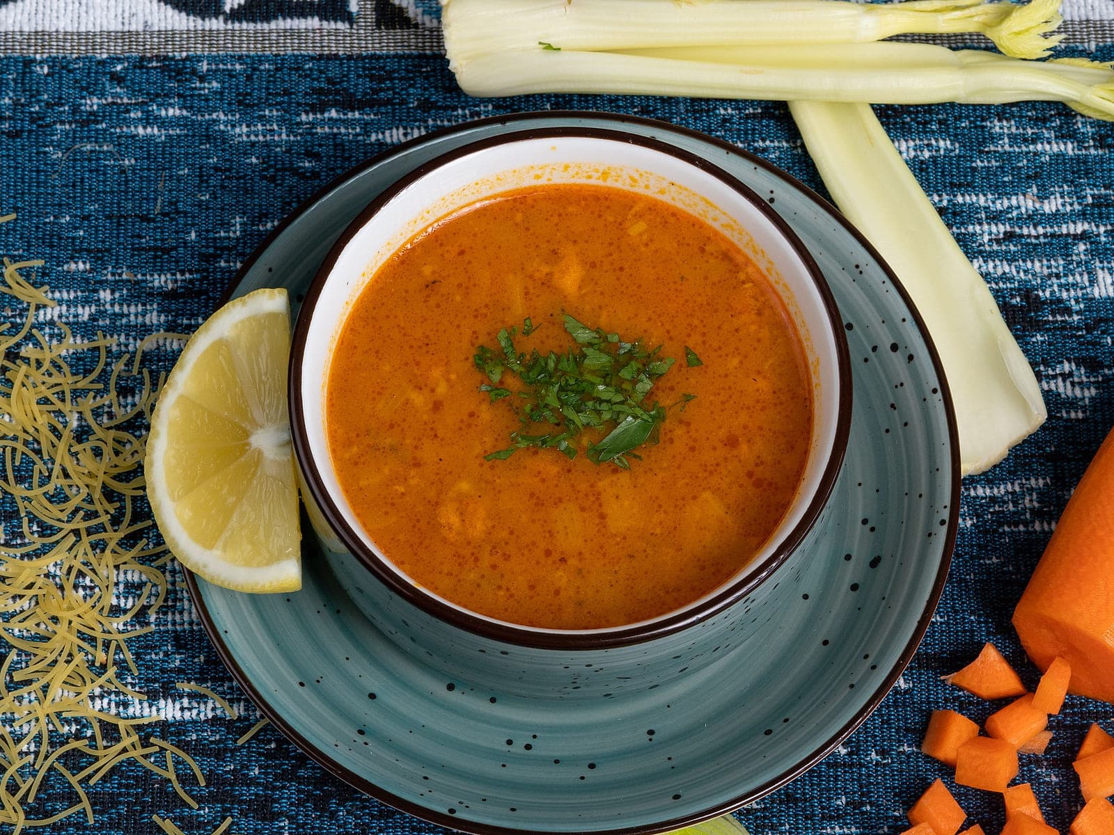 Bowl of Moroccan harira soup with chickpeas, lentils, coriander and a wedge of lemon