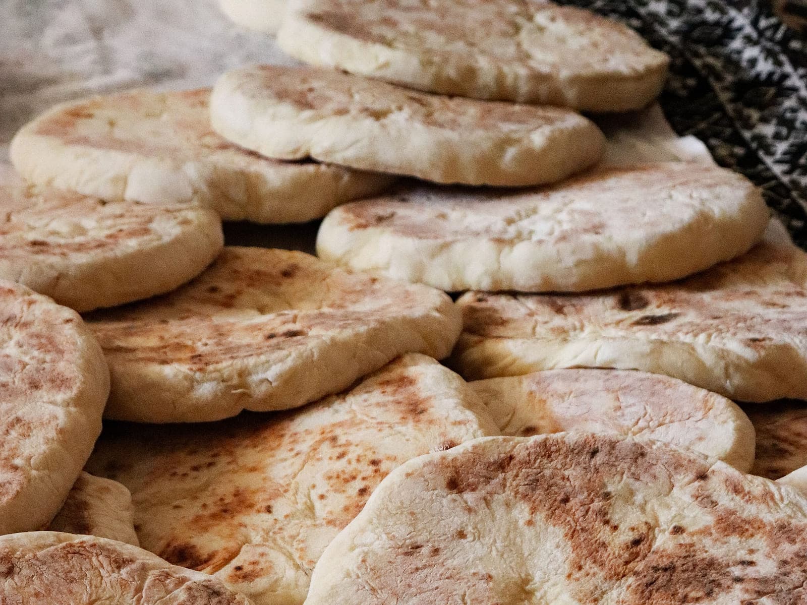 Two round loaves of Moroccan khobz bread on a wooden board